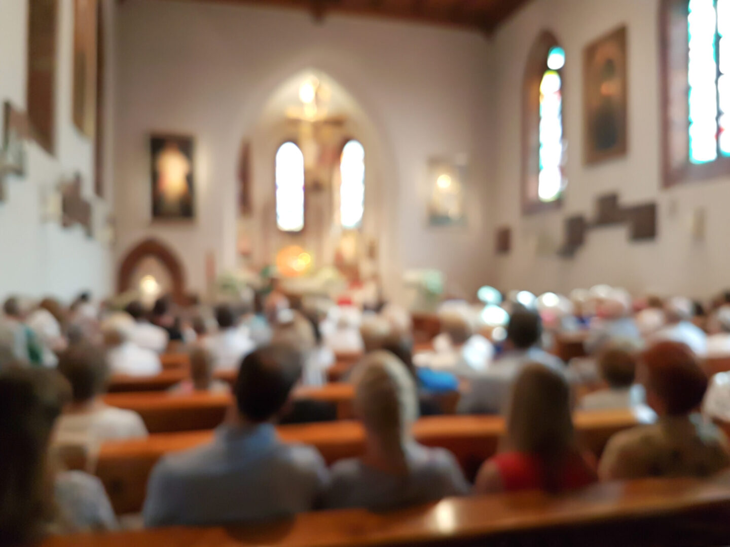 Blurred photo of praying people in the church for abstract background